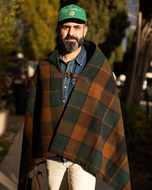 Person wearing Pine Mountain Poncho in deadstock plaid wool outdoors
