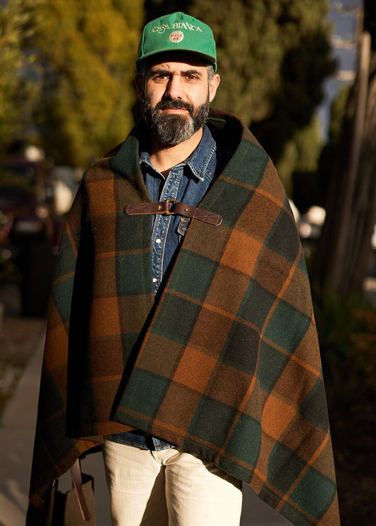 Person wearing Pine Mountain Poncho in deadstock plaid wool outdoors