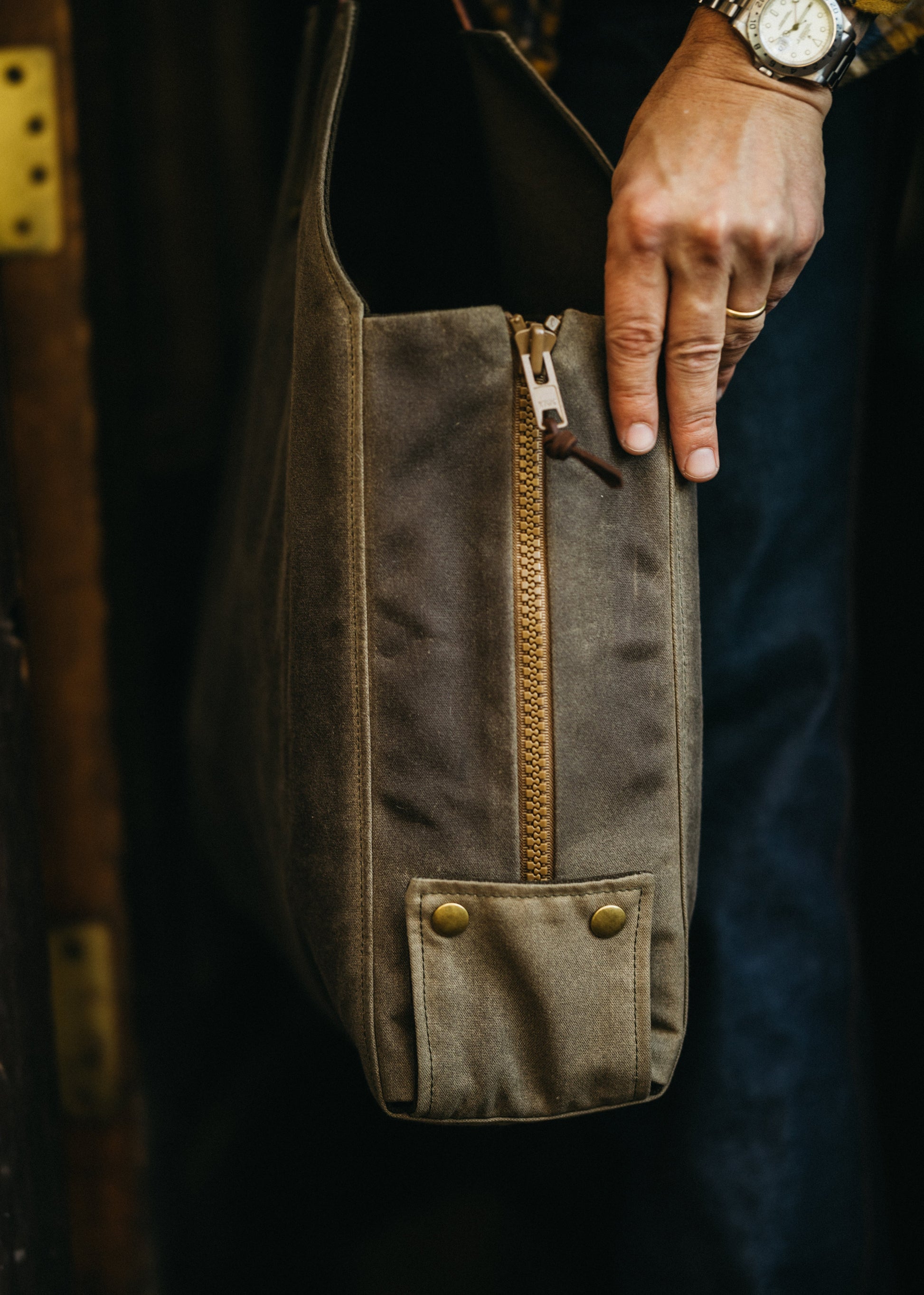 Newcomb convertible tote in brown British Millerain waxed canvas, deadstock YKK Vision zippers, and antique brass snaps
