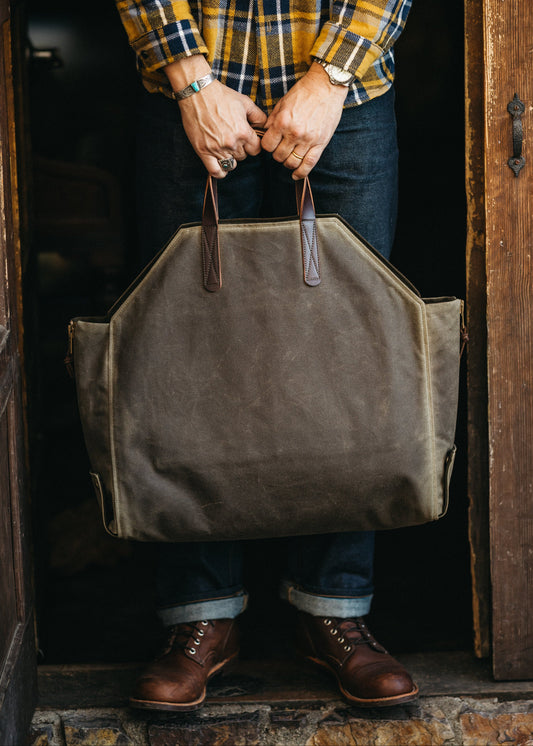 Newcomb tote in a brown waxed canvas exterior, duck canvas interior, and English Bridal leather handles