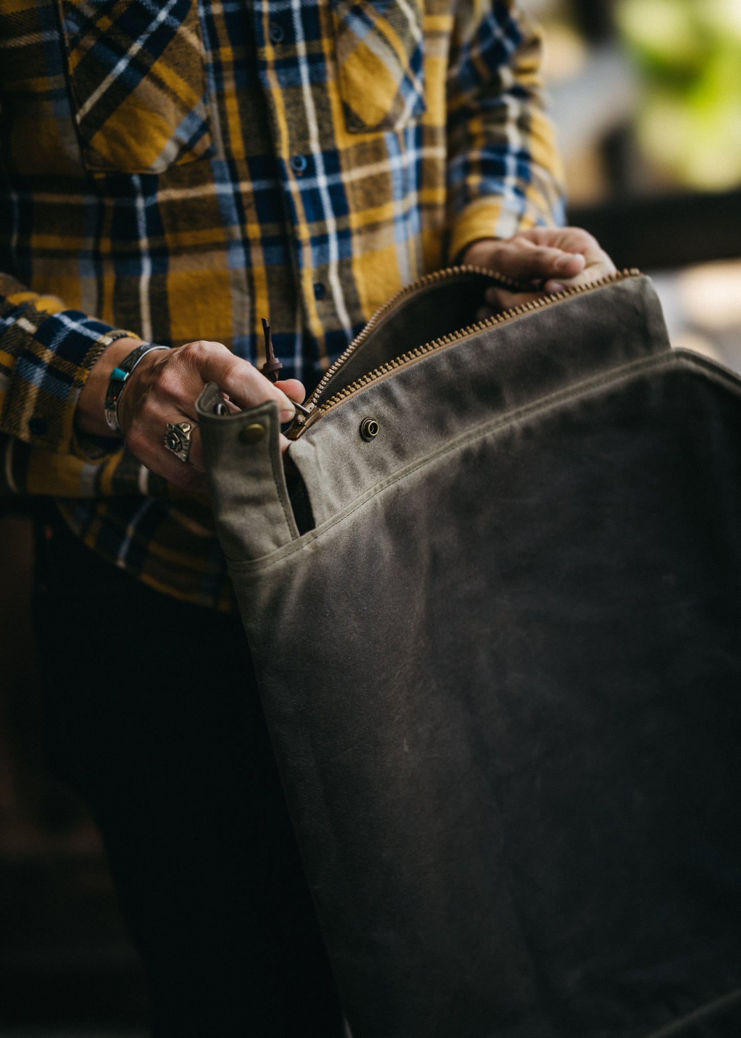 Close-up unzipping of Newcomb tote with solid brass antique snaps and deadstock Vision YKK zippers
