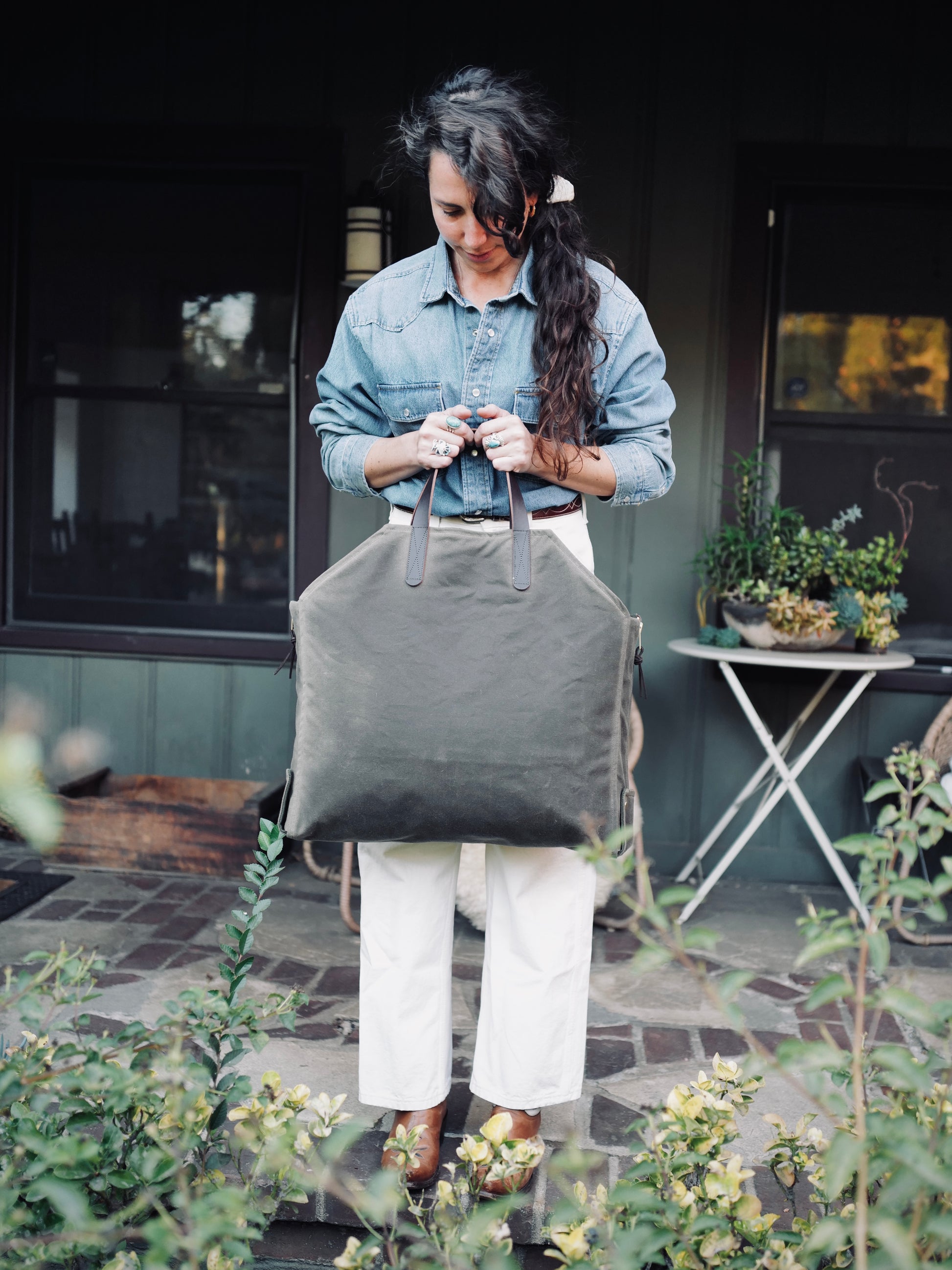 Person carrying Newcomb brown waxed canvas tote