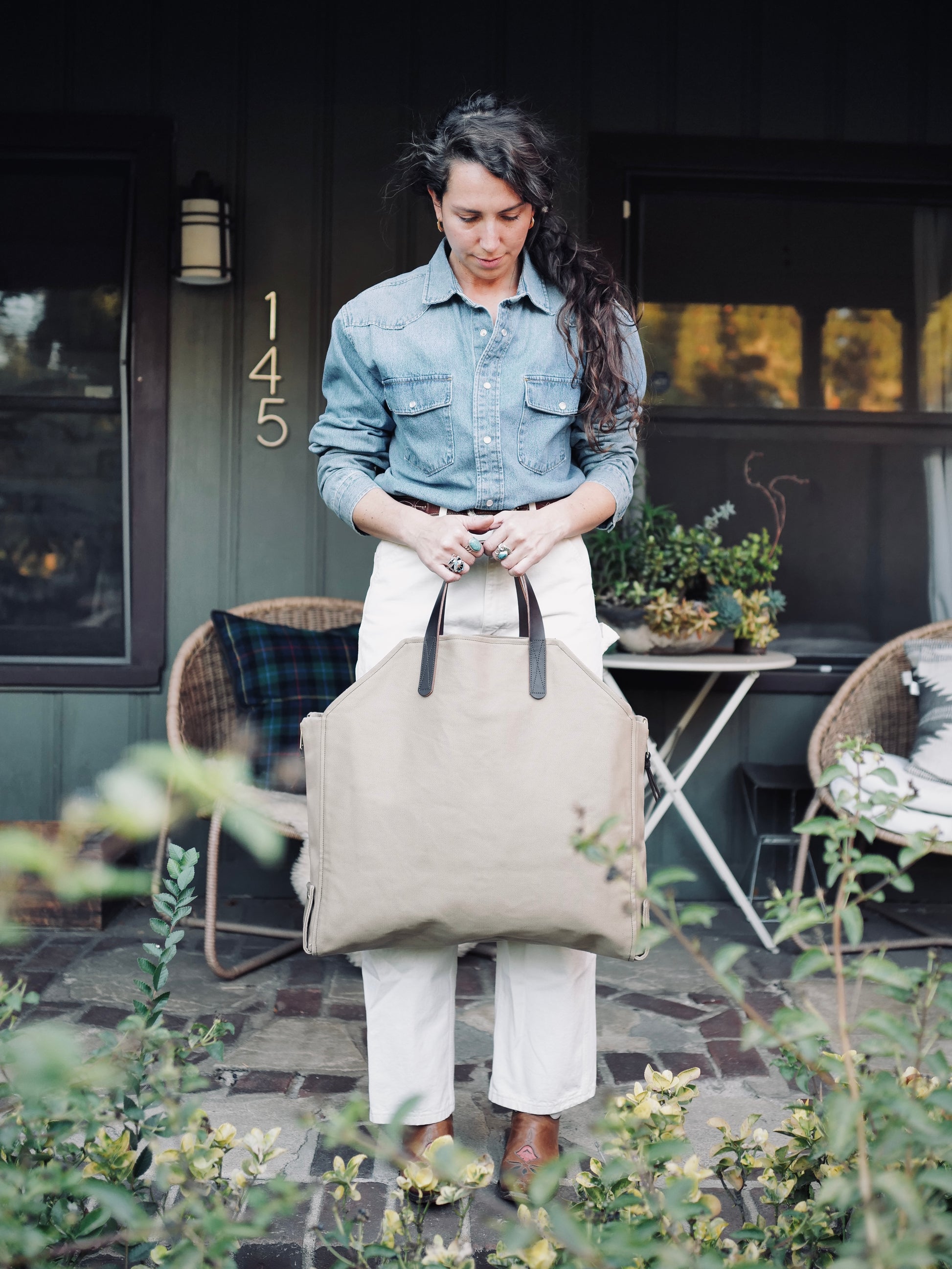 Person carrying Newcomb khaki twill  tote