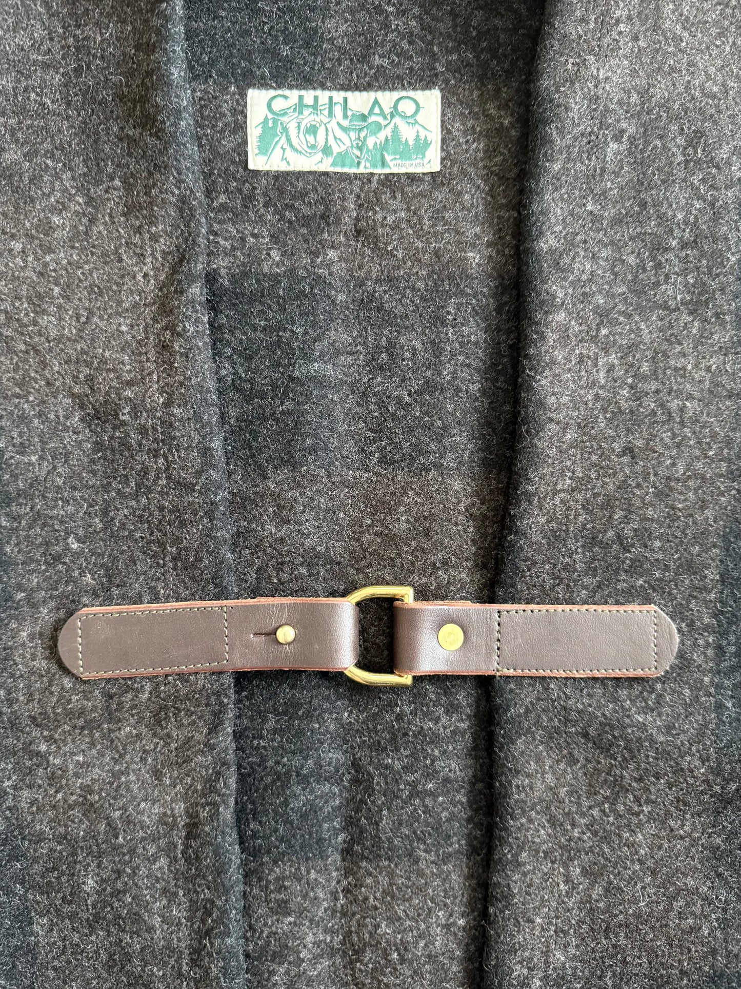 Pine Mountain Poncho leather clasp and brass hardware detail